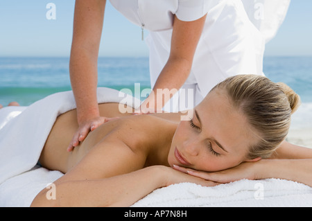 Young woman having back massaged Stock Photo