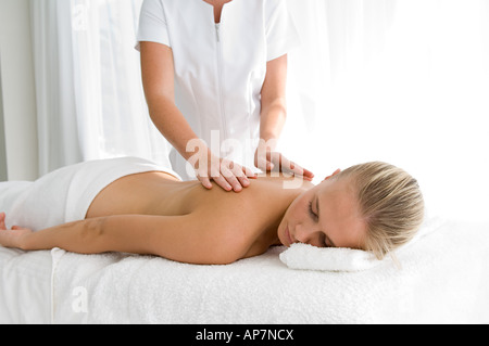 Young woman having back massaged Stock Photo