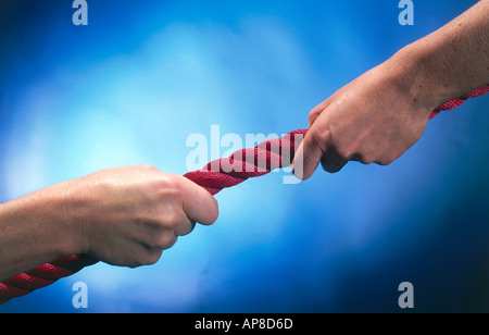 Close-up of woman in tug-of-war with man Stock Photo