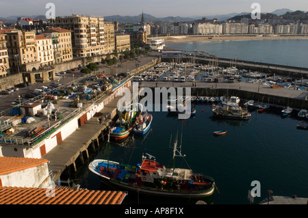 Evening view of city of San Sebastian old center on left port foreground La Concha beach in background Stock Photo