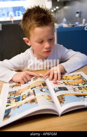 Boy is reading a comic Stock Photo
