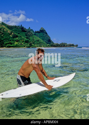 Surfer off Tunnels Beach on Kauai Stock Photo