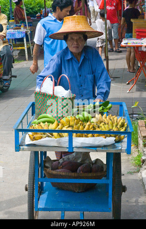 Mon Minority Woman Pushing Fruit Cart and wearing traditional Hat Ko Kret Island Bangkok Thailand Stock Photo