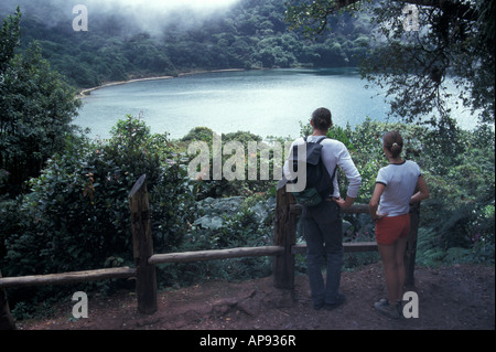 Young couple looking at Laguna Botos in the Parque Nacional Volcan Poas, Costa Rica Stock Photo