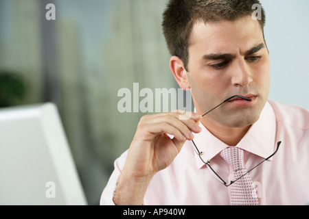 Middle Eastern businessman holding eyeglasses Stock Photo