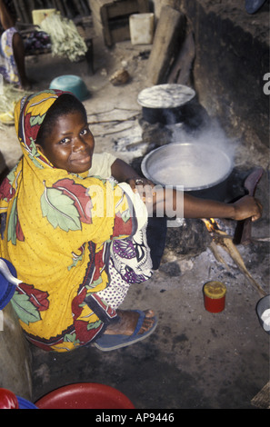 Woman cooking rice inside her hut on Lamu Island Kenya Stock Photo