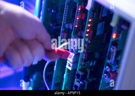 Telecoms engineer connecting electronics, close up Stock Photo