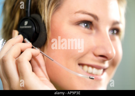 Woman using telephone headset, looking away Stock Photo