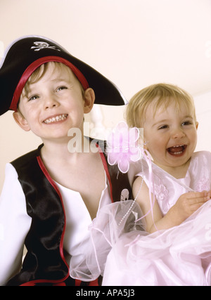Young children in fancy dress laughing and having fun Stock Photo