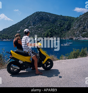 Couple On Motorscooter  Skopelos Greek Islands Greece Hellas Stock Photo