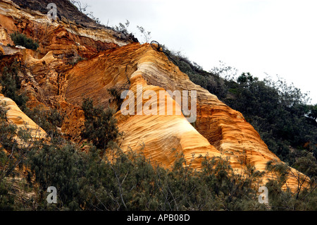 Coloured sands on Fraser Island, off Hervey Bay, Queensland Australia The sand contains minerals iron oxides and clay. Stock Photo