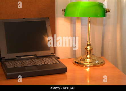 Office Desk with Laptop Computer and Bankers Lamp Stock Photo