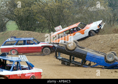 banger racing action at smallfield raceway near gatwick airport in sussex banger mk1 ford Granada pushing a volvo over the bank Stock Photo