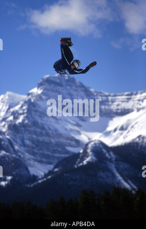 Snowboarder performing inverted jump during big air competition in Canada Stock Photo