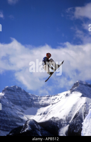 Snowboarder performing grab at big air competition in Canada Stock Photo