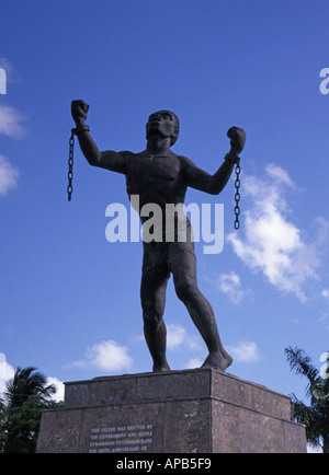 Historical slavery emancipation 'Bussa Statue' by Barbadian sculptor Karl Broodhagen symbolizing 'Breaking Of Chains' St Michael Barbados Caribbean Stock Photo