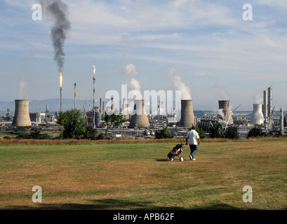 Cooling towers flame flares landmark industrial landscape at Grangemouth crude oil refinery from nearby golf course Firth of Forth Falkirk Scotland UK Stock Photo