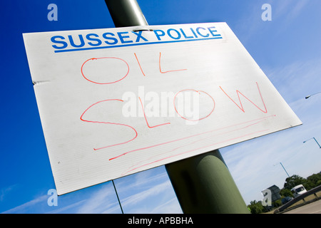 Sussex Police sign warning of oil spill on the A24 near Horsham, West Sussex Stock Photo