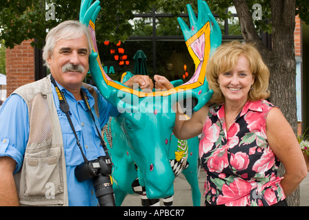Idaho COEUR D ALENE  HAPPY TOURISTS SMILING FOR THE CAMERA AGAINST MOOSE Sculpture Stock Photo