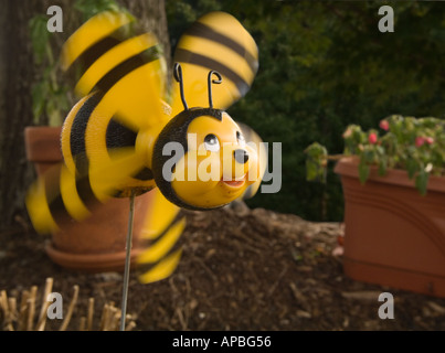 Color horizontal image of a whirligig pinwheel smiling bumblebee with wings spinning in the wind Stock Photo