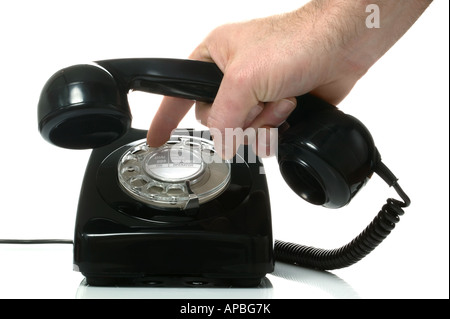 Dialling a number on an old black retro phone Stock Photo