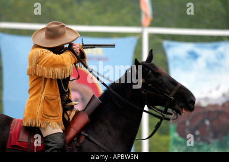 Buffalo Bill on Horseback shooting a rifle at a target at the Buffalo Bill Wild West Show Reenactment Stock Photo
