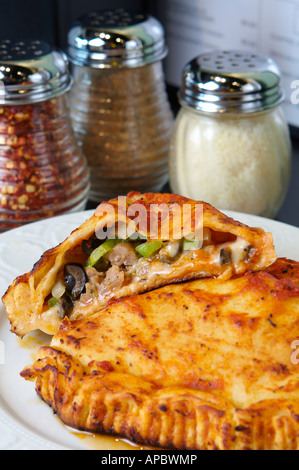 Calzone in a Italian pizzeria cut open Stock Photo