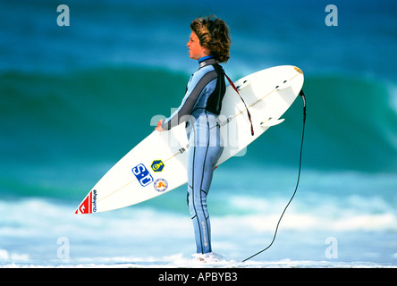 Young surfer stands looking to sea, Jeremy Flores, France Stock Photo