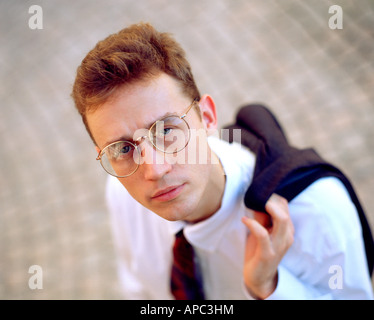 Young businessman standing looking up outdoors. MR-9-29-97 Stock Photo