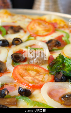 Pizza loaded with extra toppings Stock Photo