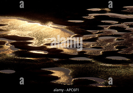 pool of water seaside beach lancashire england uk ripples in sand low light Stock Photo