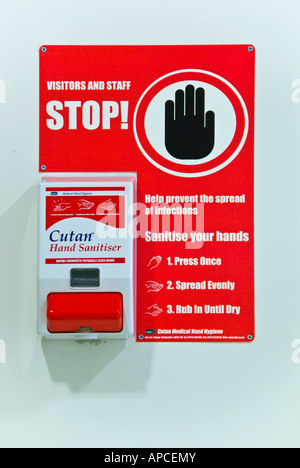 Cutan brand wall mounted NHS hospital hand sanitation unit Stop sign on dispenser & information panel for healthcare staff & visitors England UK Stock Photo