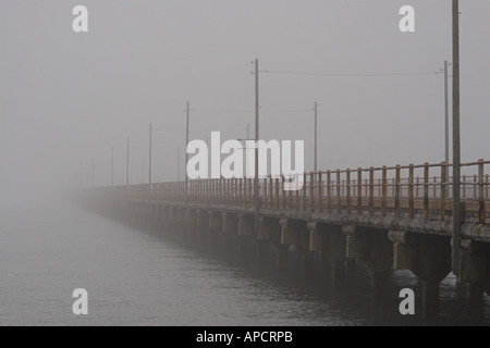 A foggy morning on the old Hornibrook Highway bridge Brighton Queensland Australia Stock Photo