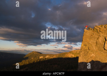 Backpacker man exploring sunset rocky mountains alone hiking