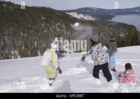 Children having a snowball fight at Homewood ski area above Lake Tahoe California Stock Photo