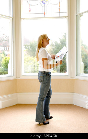 woman looking round an empty house Stock Photo
