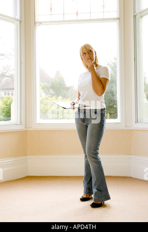 woman looking round an empty house Stock Photo