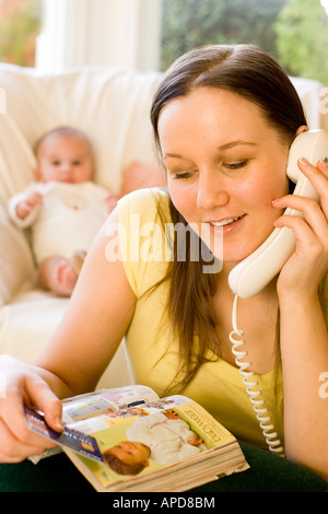Woman ordering items from catalogue Stock Photo