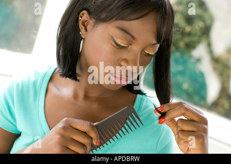 ethnic woman combing her hair Stock Photo
