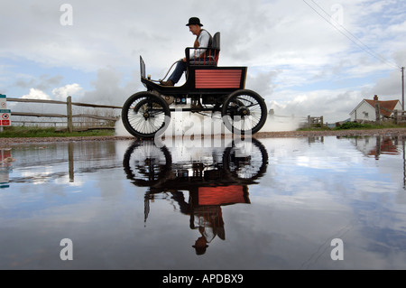 Engineer Martin Nutter drives his perfect replica of a 1902 Stanley Locomobile Spindleseat runabout steamcar through Normans Bay Stock Photo