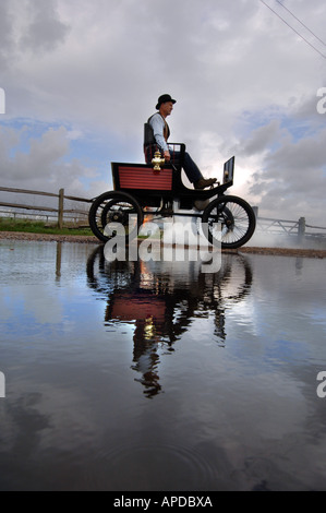 Engineer Martin Nutter drives his perfect replica of a 1902 Stanley Locomobile Spindleseat runabout steamcar through Normans Bay Stock Photo