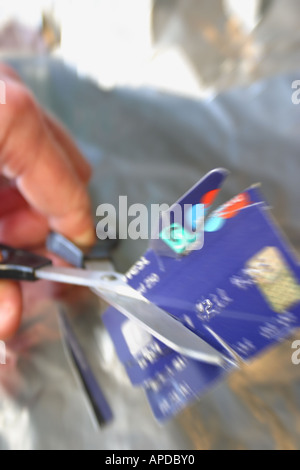 Cutting up a credit card with scissors zoom blur motion effect Stock Photo