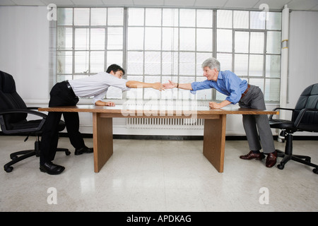 View of two business men trying to shake hands. Stock Photo
