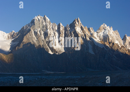 Alpenglow on mountains at sunrise on the Biafo glacier in the Karakoram Himalaya of Pakistan Stock Photo