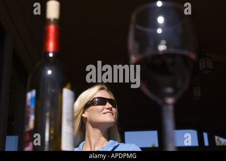 A woman with a glass of wine at Northstar ski resort near Lake Tahoe in California Stock Photo