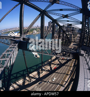 View from within the metal girder superstructure of Sydney Harbour Bridge with Bennelong Point Opera House Sydney Australia Stock Photo