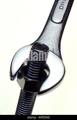 Wrench twisting nut off bolt Stock Photo