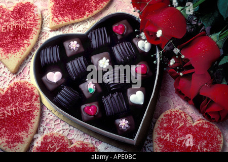 valentine candy in heart shaped box with cookies and red roses Stock Photo