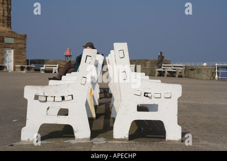 Seats on the harbour wall at Whitby, North Yorkshire Stock Photo