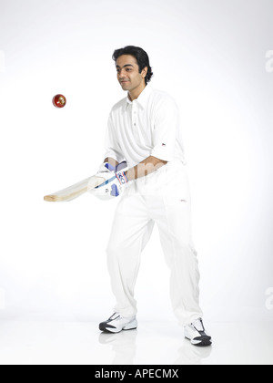 Indian batsman bouncing ball in air with bat Stock Photo